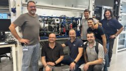 Iimage of a group of men in front of fuel cell