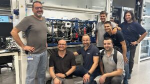 Iimage of a group of men in front of fuel cell