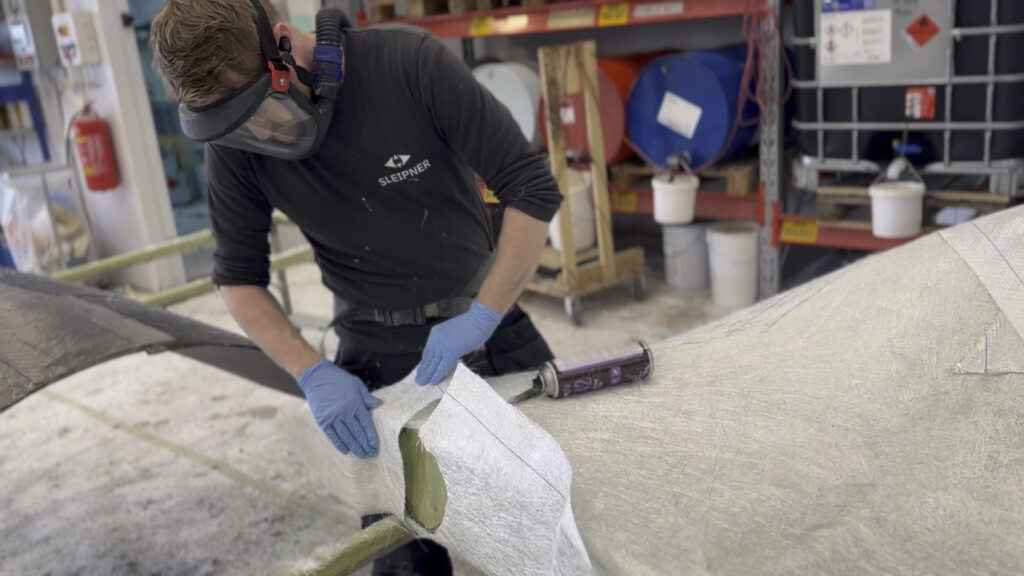 Composite technician preparing layers for Vector Fins. Each stabilizer fin is built with care to ensure optimal performance on the water.