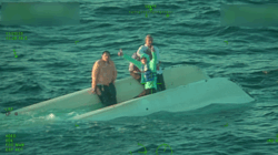 Passengers on capsized catamaran await rescue