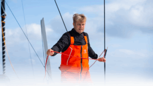 Oliver Heer dressed in orange aboard his boat