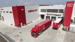 Two lorries outside redn and white factory