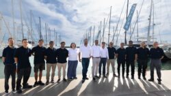 Team photo in marina against blue sky