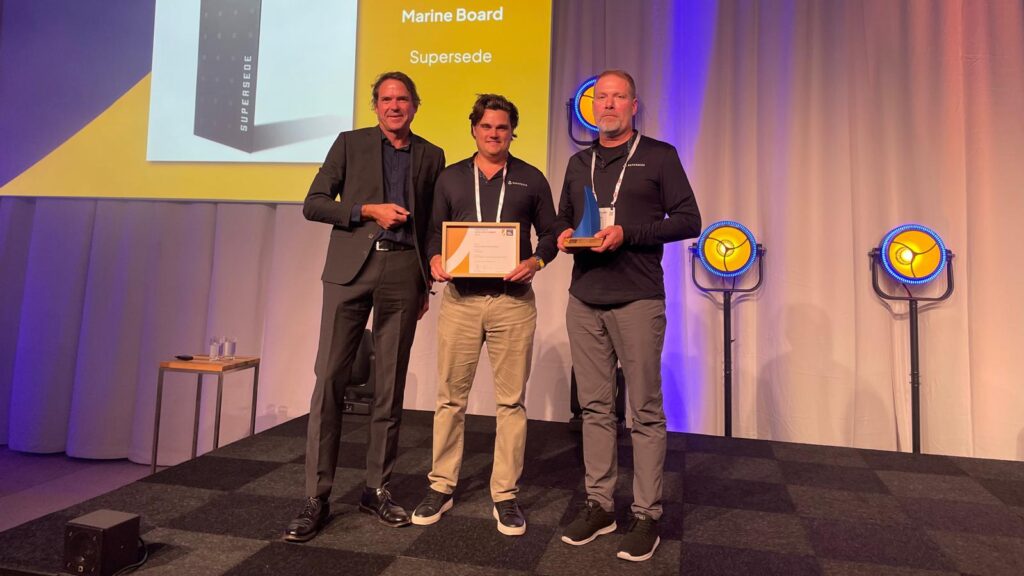 supersede win Dame award for marine grade alternative to plywood - three people on stage