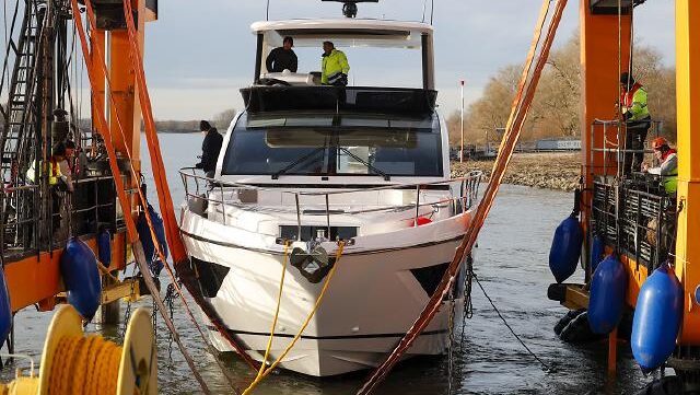 Yacht crane lifting motor yacht out of water for boot Dusseldorf show