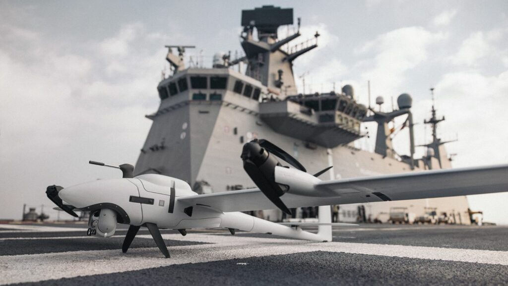 drone infront of a warship in port