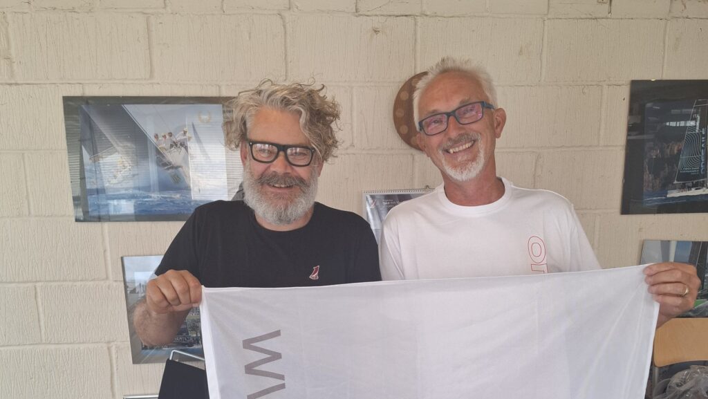 Daryl Morgan from OneSails poses with a onesails flag