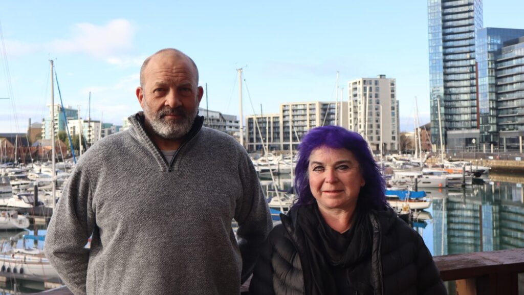 couple standing in front of Ocean Village Marina in Southampton