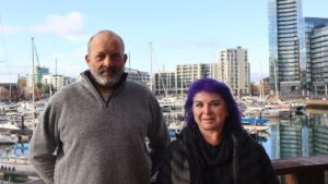 couple standing in front of Ocean Village Marina in Southampton