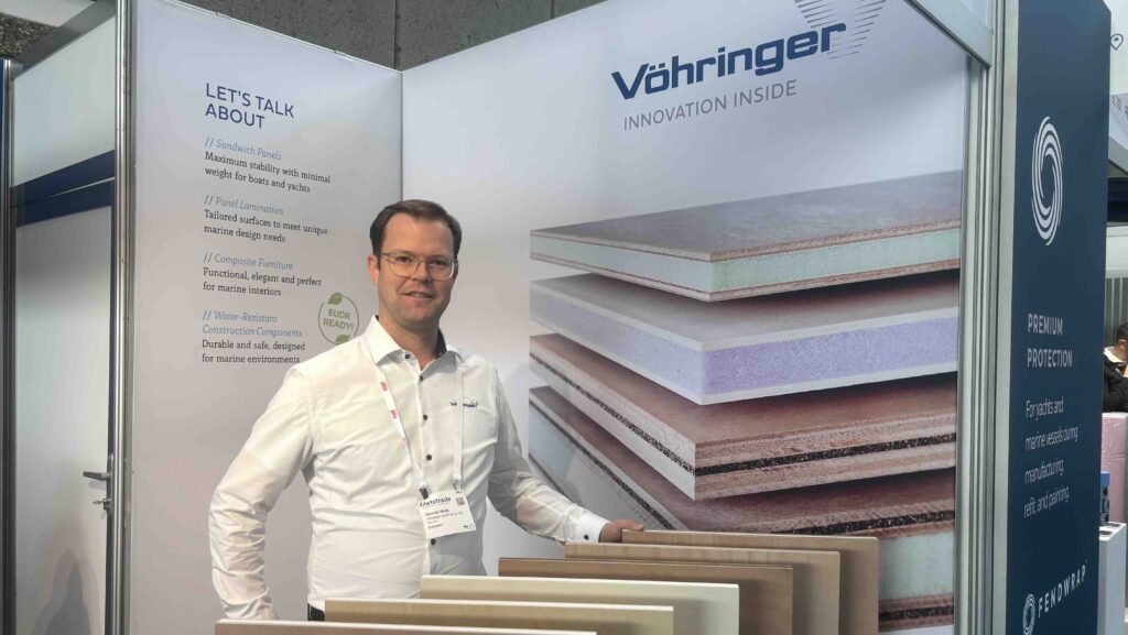 man standing smiling on exhibition stand