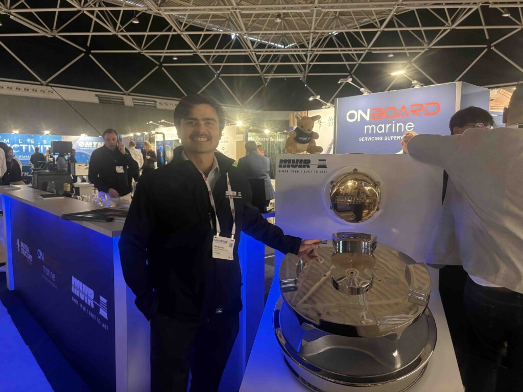 man on exhibition stand smiling