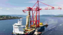 Ship with crane on in middle of Clyde