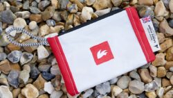 Rooster's document holder made out of recycled sailcloth bags on a pebble beach