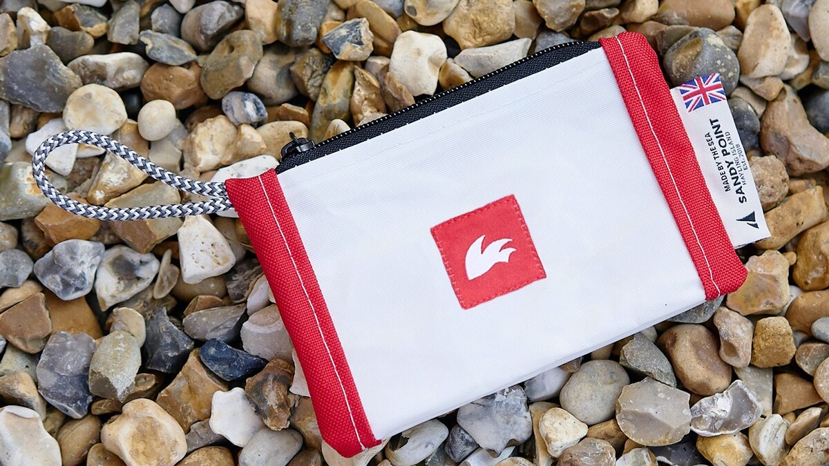 Rooster's document holder made out of recycled sailcloth bags on a pebble beach