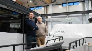 Two men standing on a boat in a factory