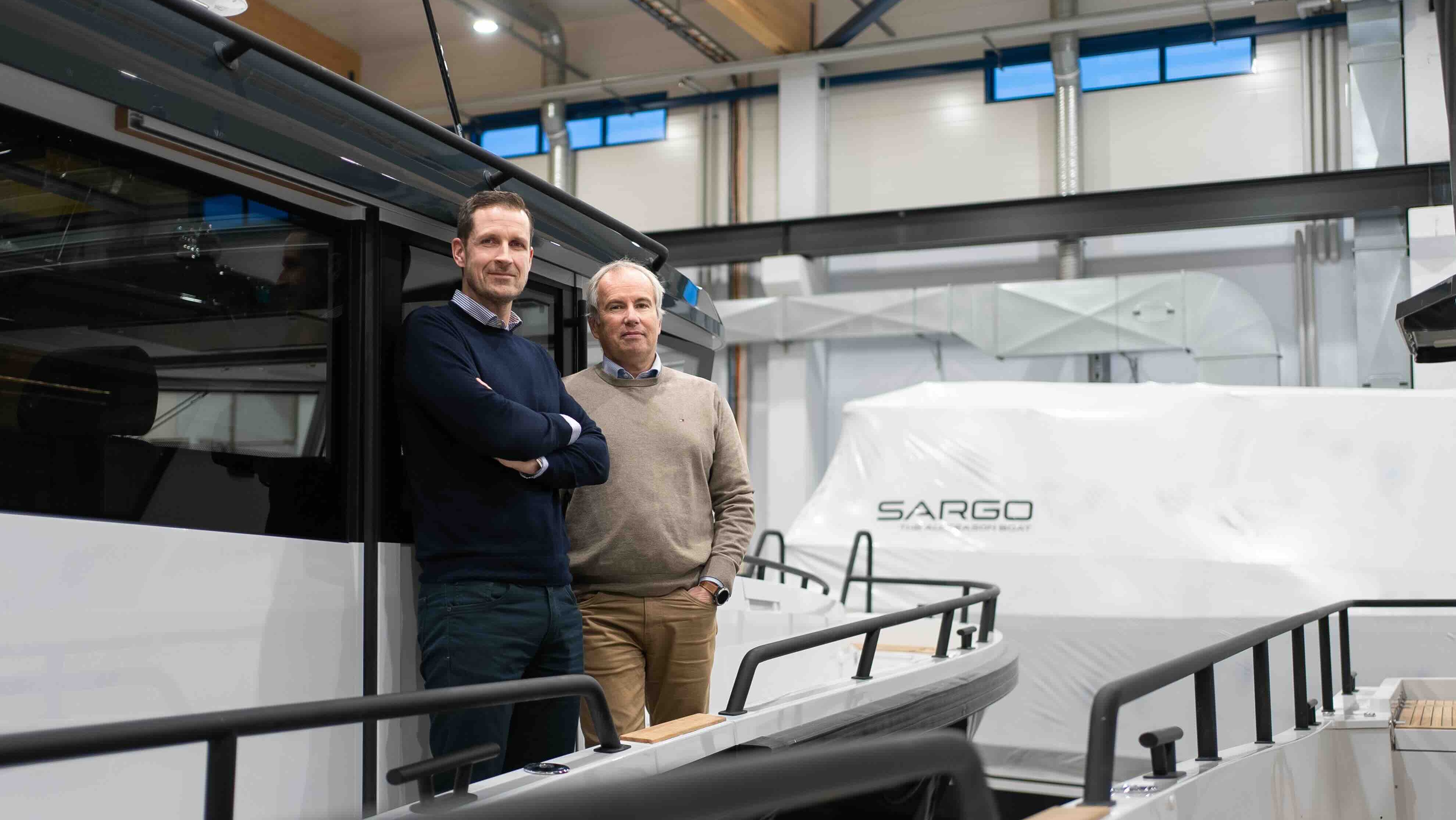 Two men standing on a boat in a factory