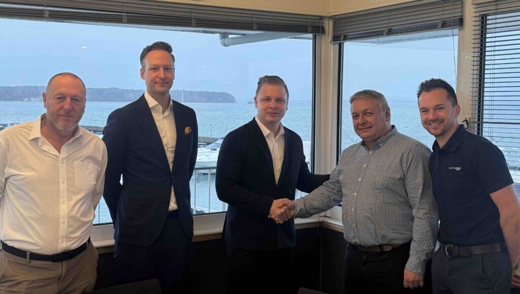 group of five men in office.Two shaking hands