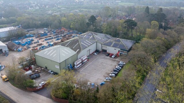 aerial view of small factory surrounded by trees