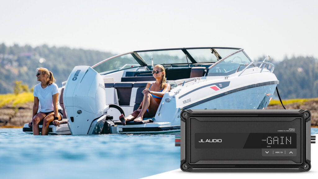 Two women on outboard boat with a product image of Garmin's new JL Audio amplifier in foreground