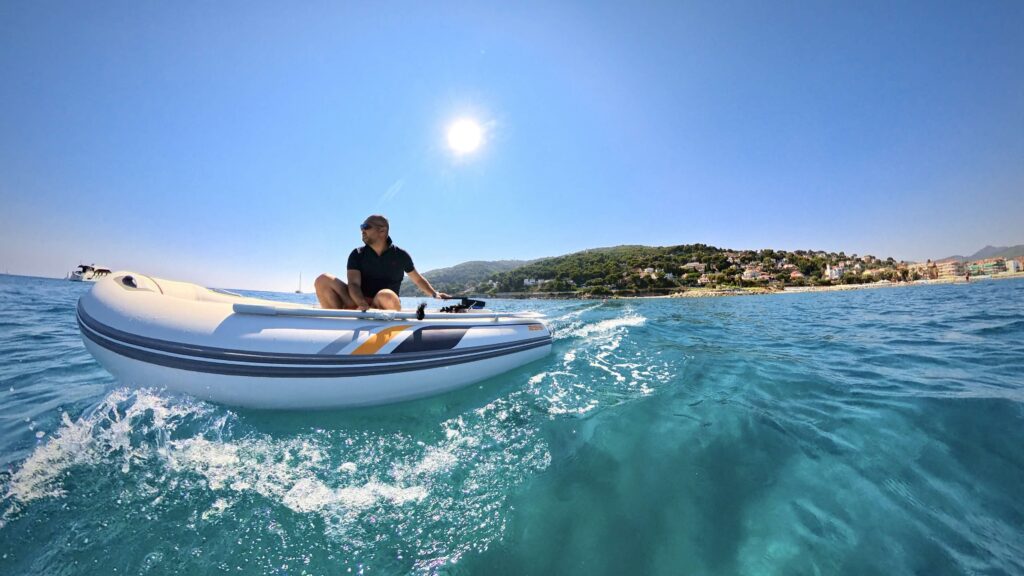 man on an eelctric RIB boat in summer