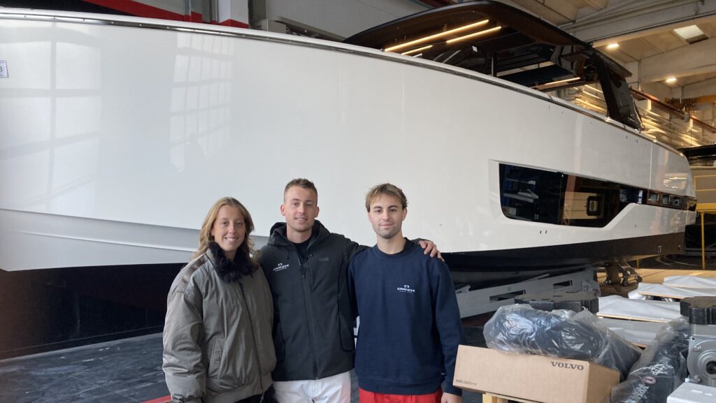 Cranchi cousins Carlotta Lucini sales management and exhibition manager, Filippo Lucini production manager of plant one and Federico Cranchi pictured in front of boat in factory