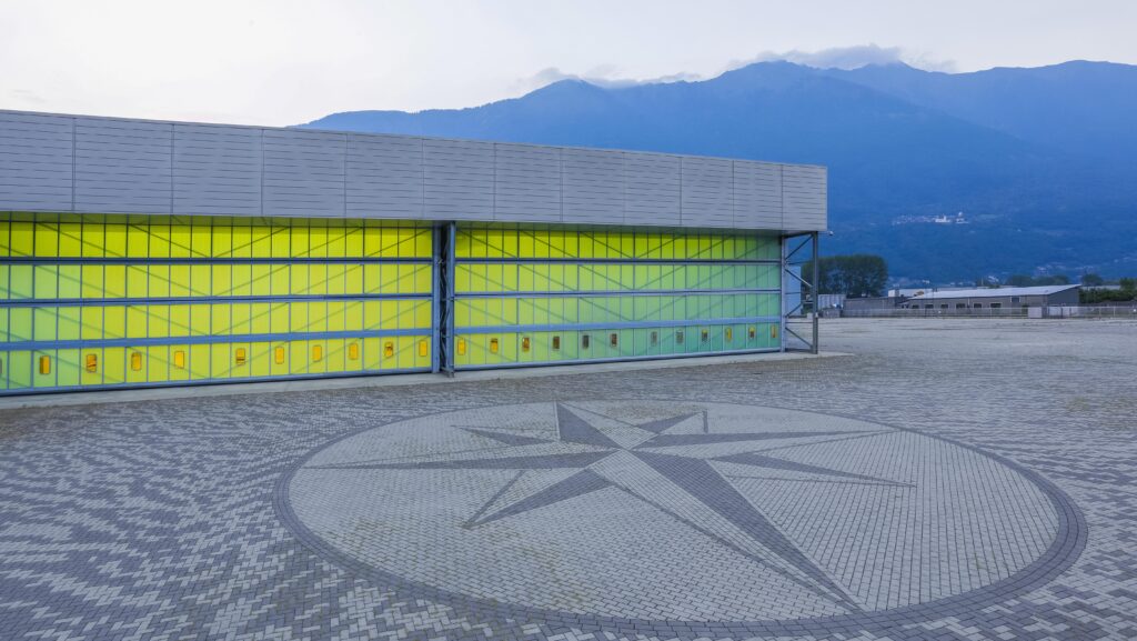 Cranchi is nestled at foot of Italian Alps - plant with mountains behind