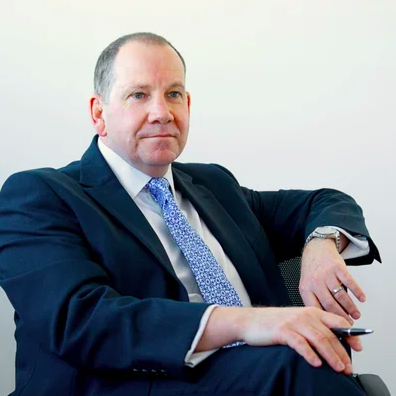 Jon Patrick Christie and Co  sat in chair holding pen