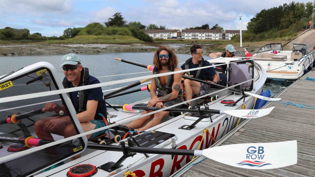 rowers in large row boat by pontoon for GB Row Challenge