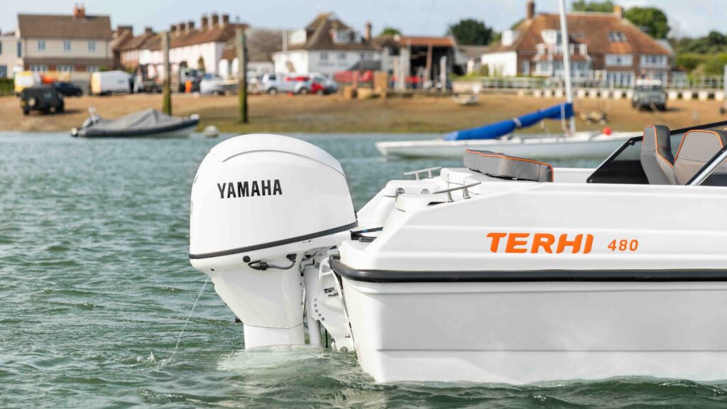 White Terhi Boat hull with Yamaha outboard installed