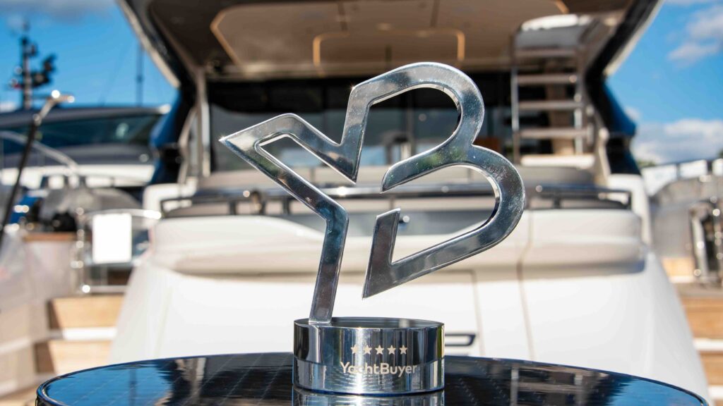 A Silver award with aft luxury yacht in the background
