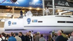Sailing boat in hall at boot Düsseldorf with people walking by