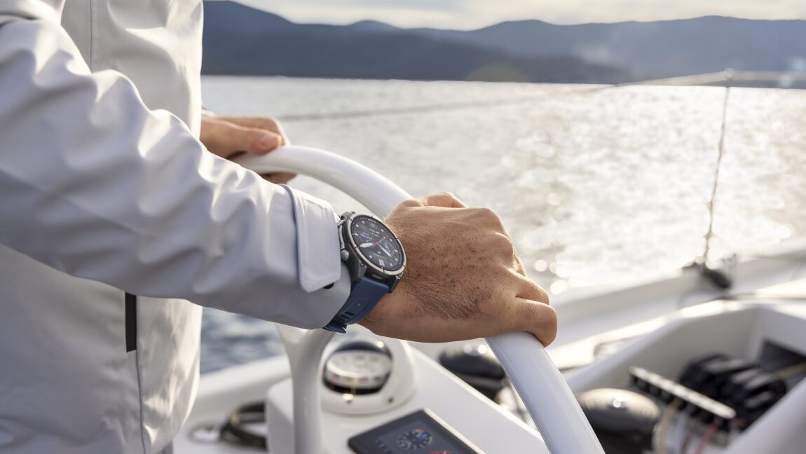 Garmin Quatix 8 Pro watch on a wrist at helm