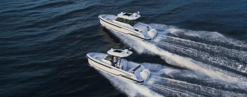 two 28-foot motor boats powerihng across the water