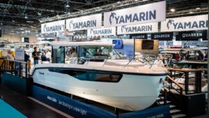 Yamarin Aura Cabin pilothouse boat on an indoor exhibition stand