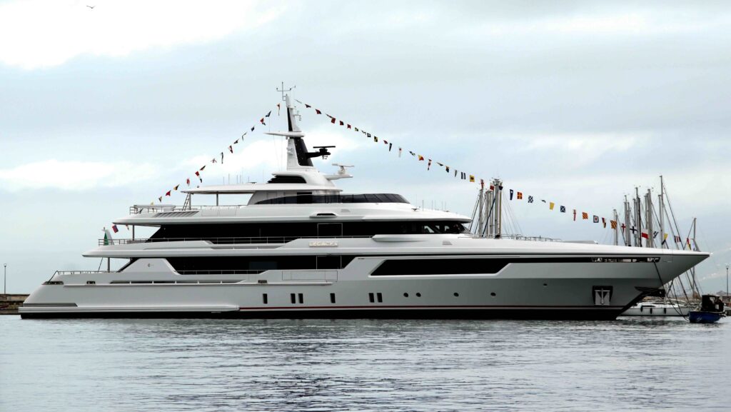 Large white superyacht with bunting