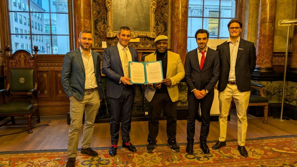 Group of men in suits holding certificate