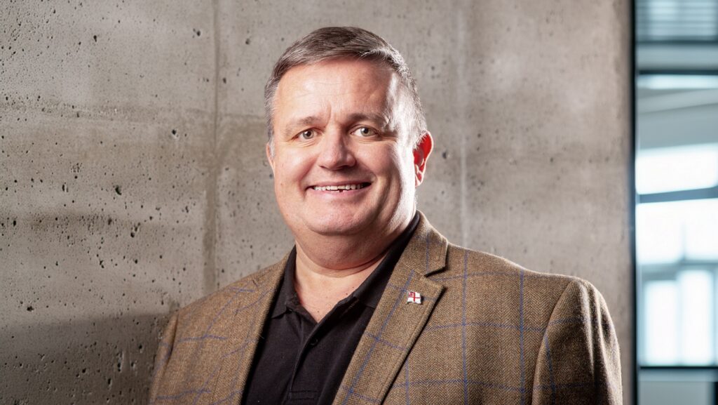 Head shot of man in brown jacket. Mike Collier from Zelim