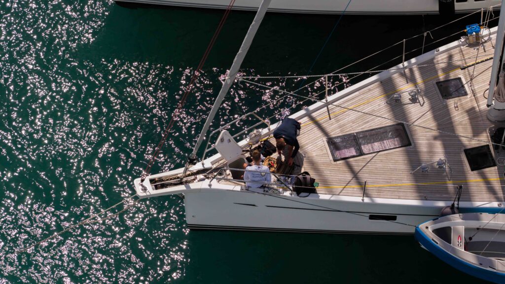 Aerial view of bow of Oyster yacht with crew working
