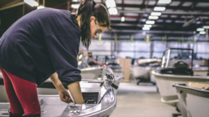 woman in factory working on boat hull