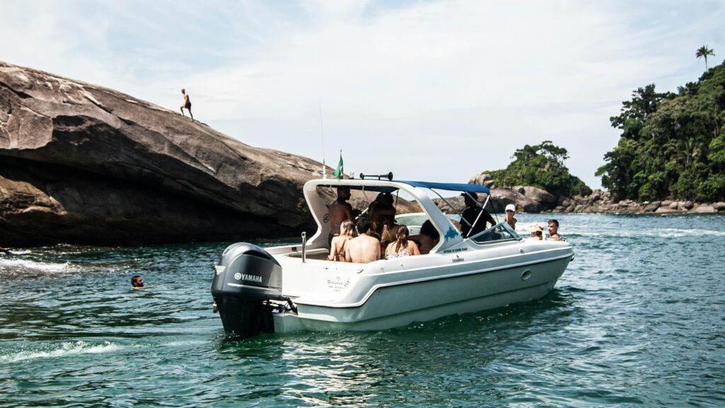 Group of people in white and blue motor boat on body of water