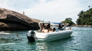 Group of people in white and blue motor boat on body of water