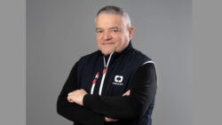 Studio shot of man in dark sailing jacket with arms crossed