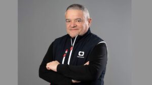 Studio shot of man in dark sailing jacket with arms crossed