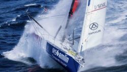 Racing yacht heeling over with spray