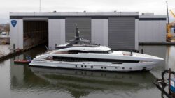 white 50-metre superyacht on the water at a shipyard
