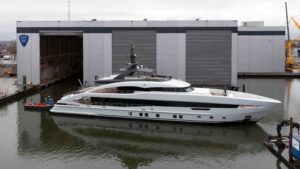 white 50-metre superyacht on the water at a shipyard