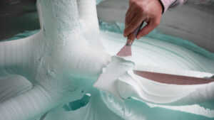 close up of hand applying coating to a mould