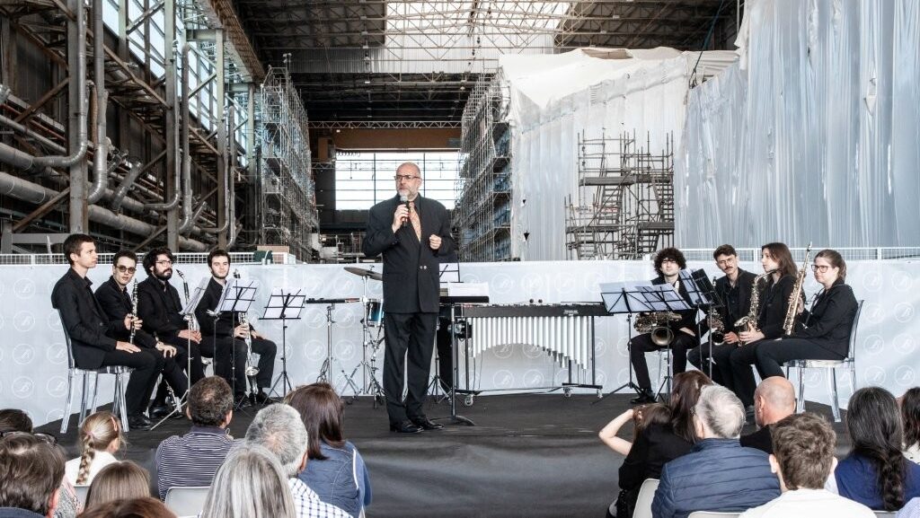Classical musicians on small stage in boat yard