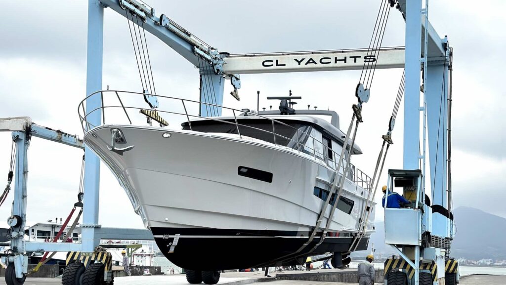 Large motorboat in shipyard hoist