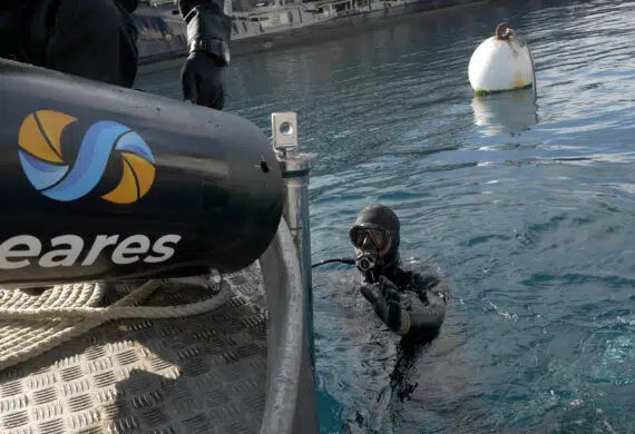 diver in the water by marine berth